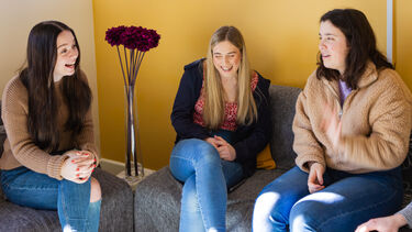 Group laughing in living area 