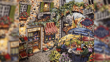 Pam's intricate cross-stitch of a European style piazza and cafe scene