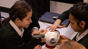 A group of children with a MiRo robot