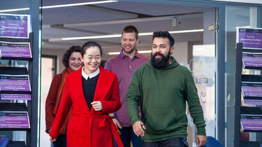 Four students exiting the Futures First employability hub in the Management School
