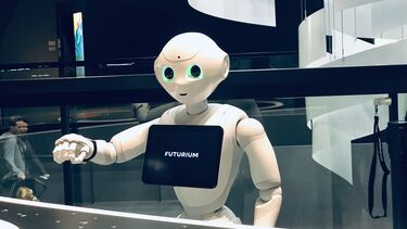 A robot with a friendly face at an expo