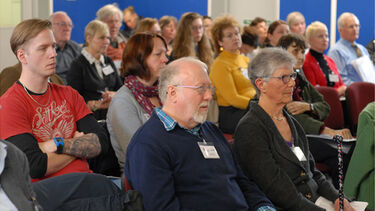 An audience listening to a presentation