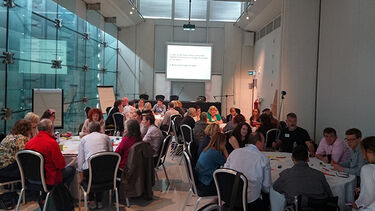 Groups sitting at tables as part of a workshop