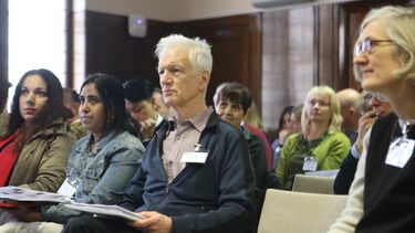 An audience listening to a presentation