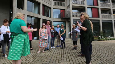 A woman talking to a group at Park Hill, Sheffield.