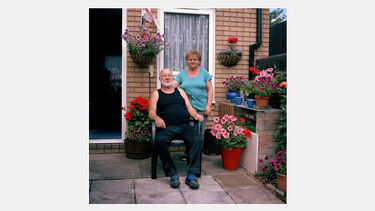 A couple in the yard of their house in Hillfields