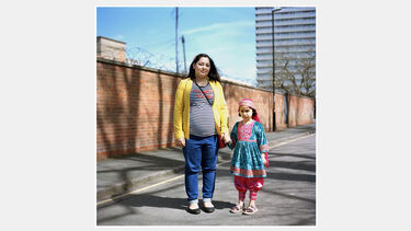 A young mother with child in traditional Asian dress on the street in Hillfields