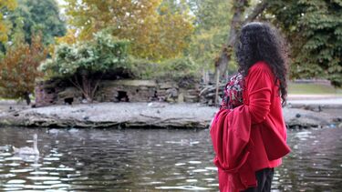 A woman stood in front of a pond