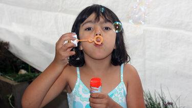 A girl blowing bubbles
