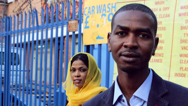 Portrait of a man and a woman outside a car wash