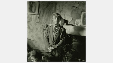 A vintage photo of a man in his living room in 1950s Coventry