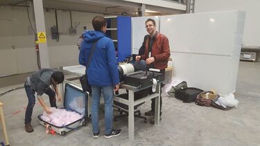 People sorting equipment at a table