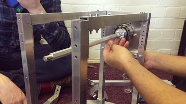 A close up of team members assembling parts