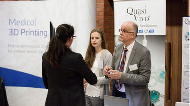 A group having a conversation at the Insigneo showcase 2017.