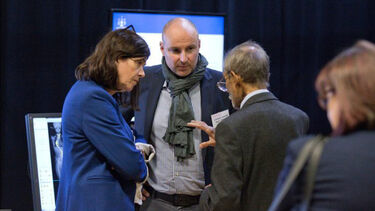 A group having a conversation at the Insigneo showcase 2017.