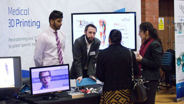 A group having a conversation at the Insigneo showcase 2017.