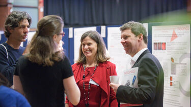A group having a conversation at the Insigneo showcase 2019.
