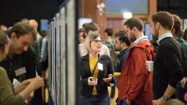 A group having a conversation at the Insigneo showcase 2019.