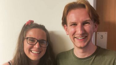 Young woman and young man smiling