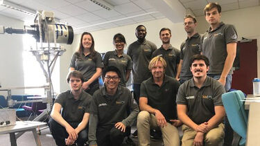 A group photo of the team with the reviewer