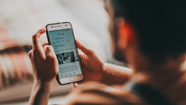 A person reading the news on a mobile phone