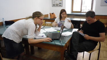 Three participants working together in the Advocate workshop