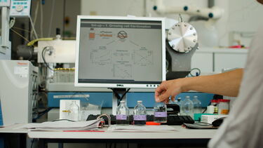 Scientific samples in front of a computer monitor