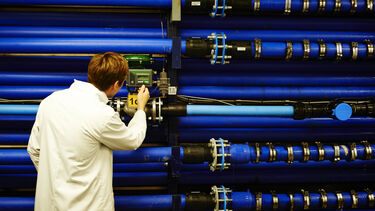 Student looking at pipes