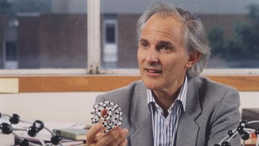 Sir Harry Kroto holding a C60 model
