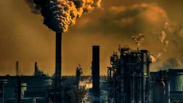 Smoke billowing out of chimney in power plant