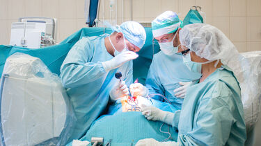 A team of spine surgeons working on a patient