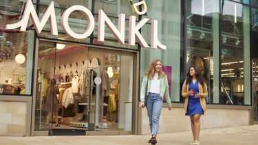 Two students walking outside Monki in Sheffield city centre