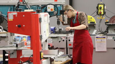 A student making something using machinery in the iForge