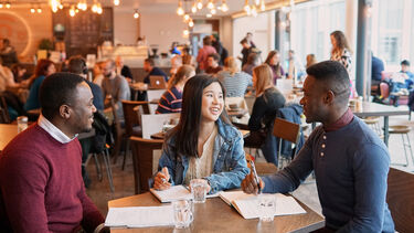 Three people sat in a cafe