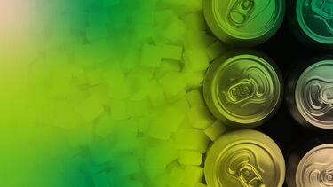 Drinks cans next to a pile of sugar cubes.