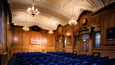 Grand hall with chairs and wooden panelling 