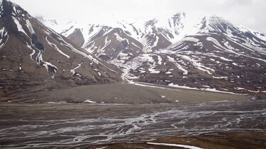 Partially thawed snowy mountain scene