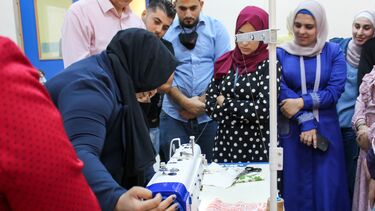 An image of a woman using a sewing machine