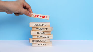 Wooden blocks. The top reads 'Compliance'.