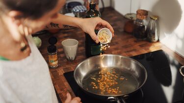 Person cooking with frying pan