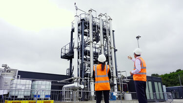 Energy Institute members stand in front of some of the Institute's testing facilities. 