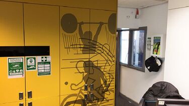 A photo of the swimming pool lobby showing the location of a defibrillator.