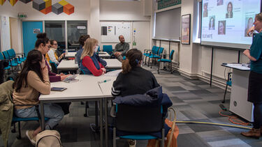 An Elevate adviser running a workshop in the Elevate hub with 10 attendees.