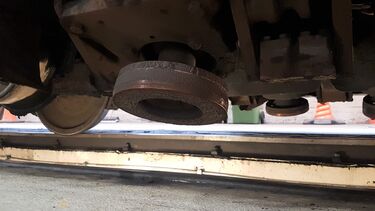 Grinding wheel with the abrasive particles mounted on the train above a rail