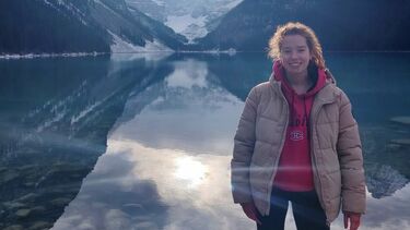 Sadie standing in front of Lake Louise in Alberta, Canada