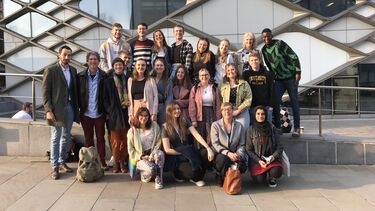 Grouo of about 20 students with tutors and guest author