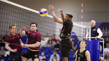 Students playing volleyball at Varsity