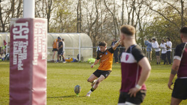 Students playing rugby at varsity match