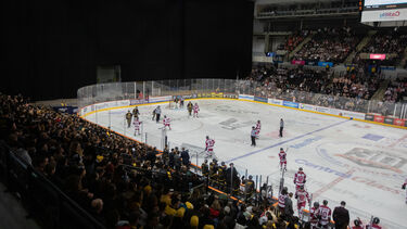 Student playing ice hockey at varsity