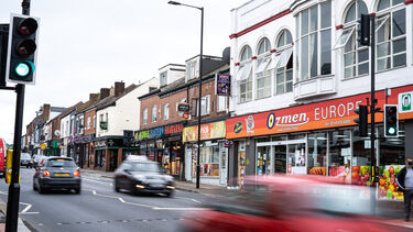 Cars driving on London Road past Ozmen supermarket